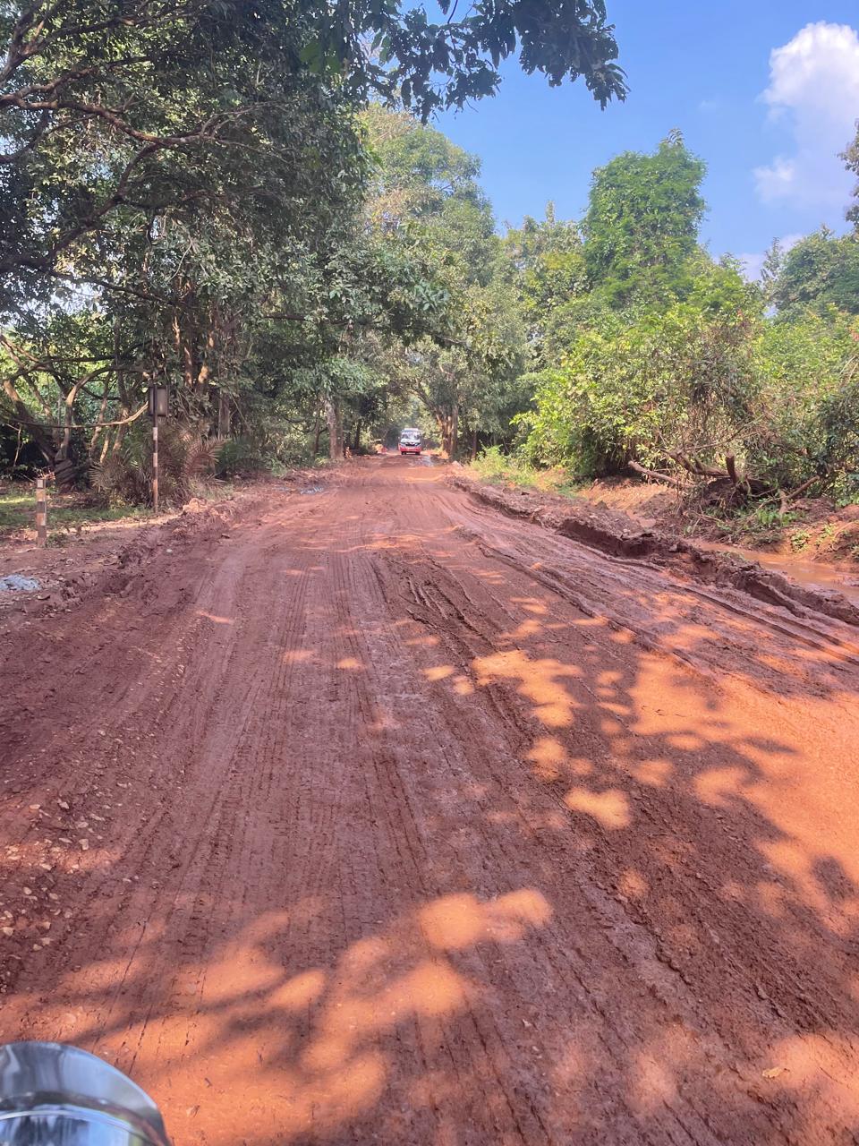 A broken road in the forest covered in mud