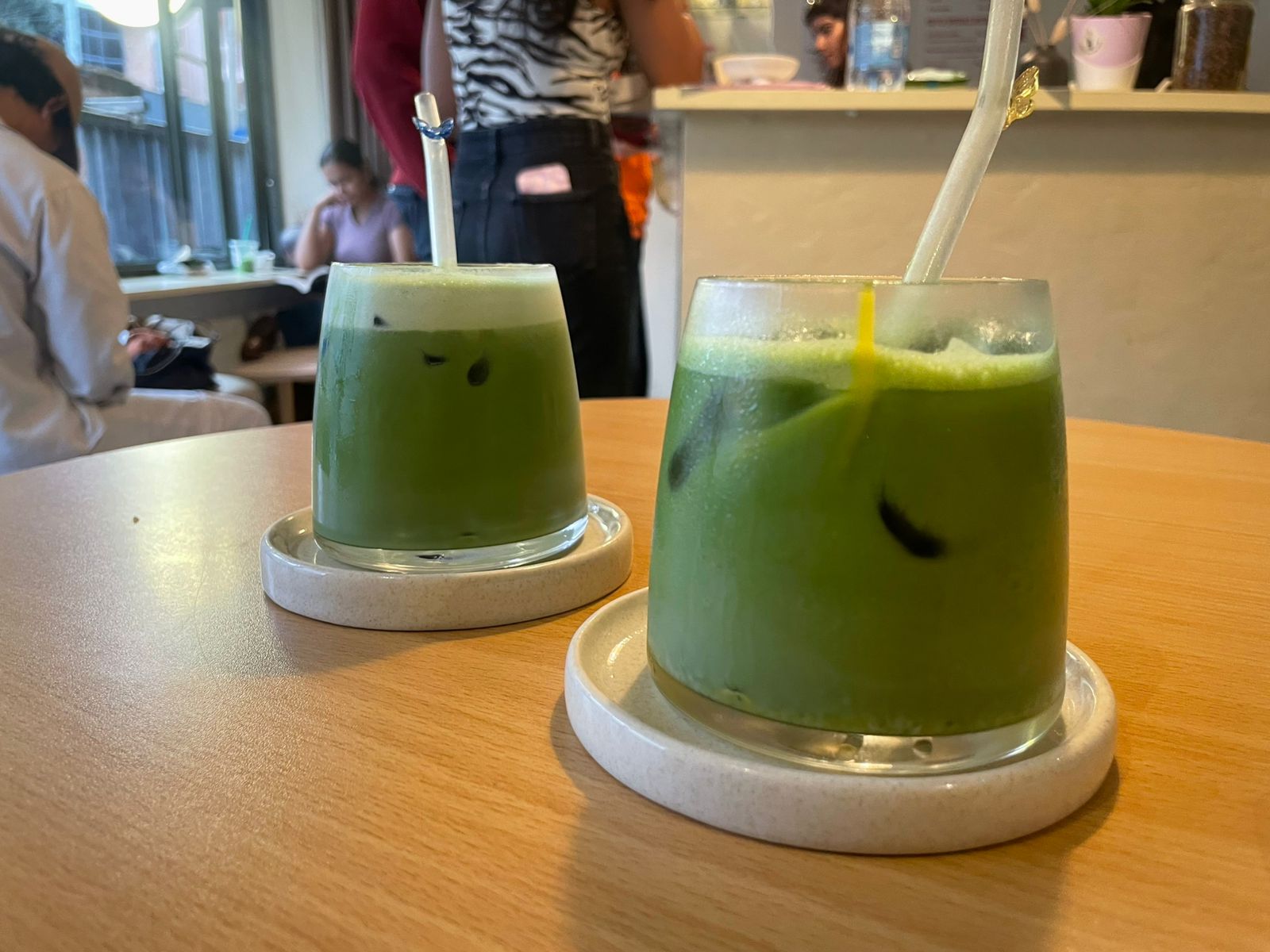 Two green glasses with matcha drink