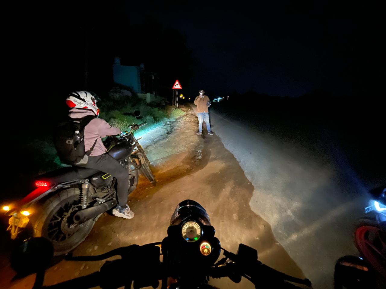 3 bikes parked on the curb at night
