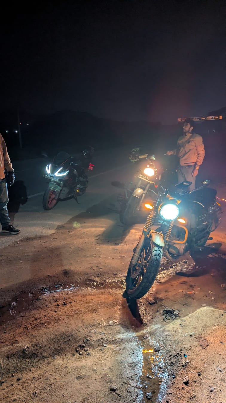 3 bikes parked on the curb at night